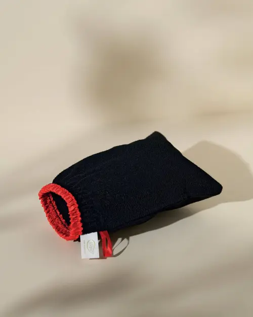 Peeling-Handschuh Best Kessa Alepia aus körnigem schwarzem Stoff mit rotem elastischem Rand